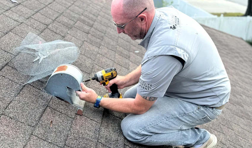 Dr. Critter technician on a Central Florida roof sealing a vent after an emergency wildlife removal